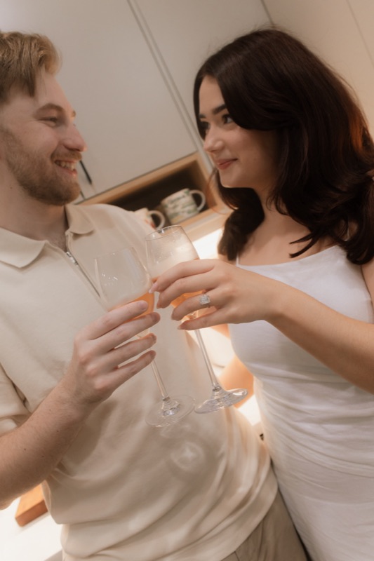 Kaylee and David laughing over a champagne toast