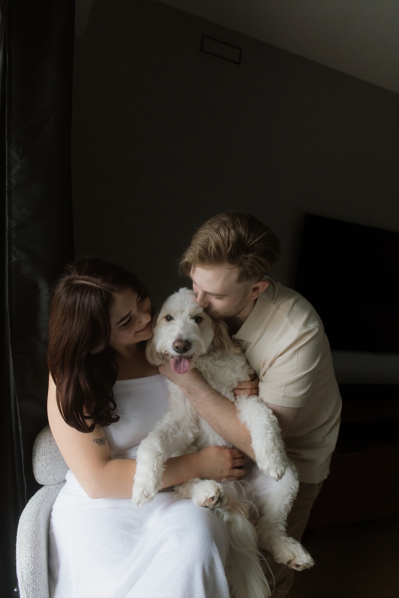 Kaylee holding Monty while David kisses his head