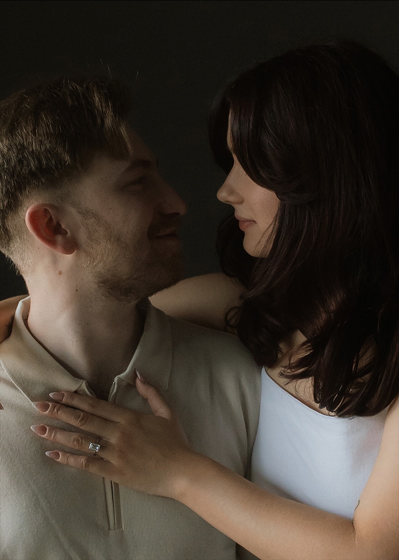 Kaylee's hand on David's chest, the ring catching the light