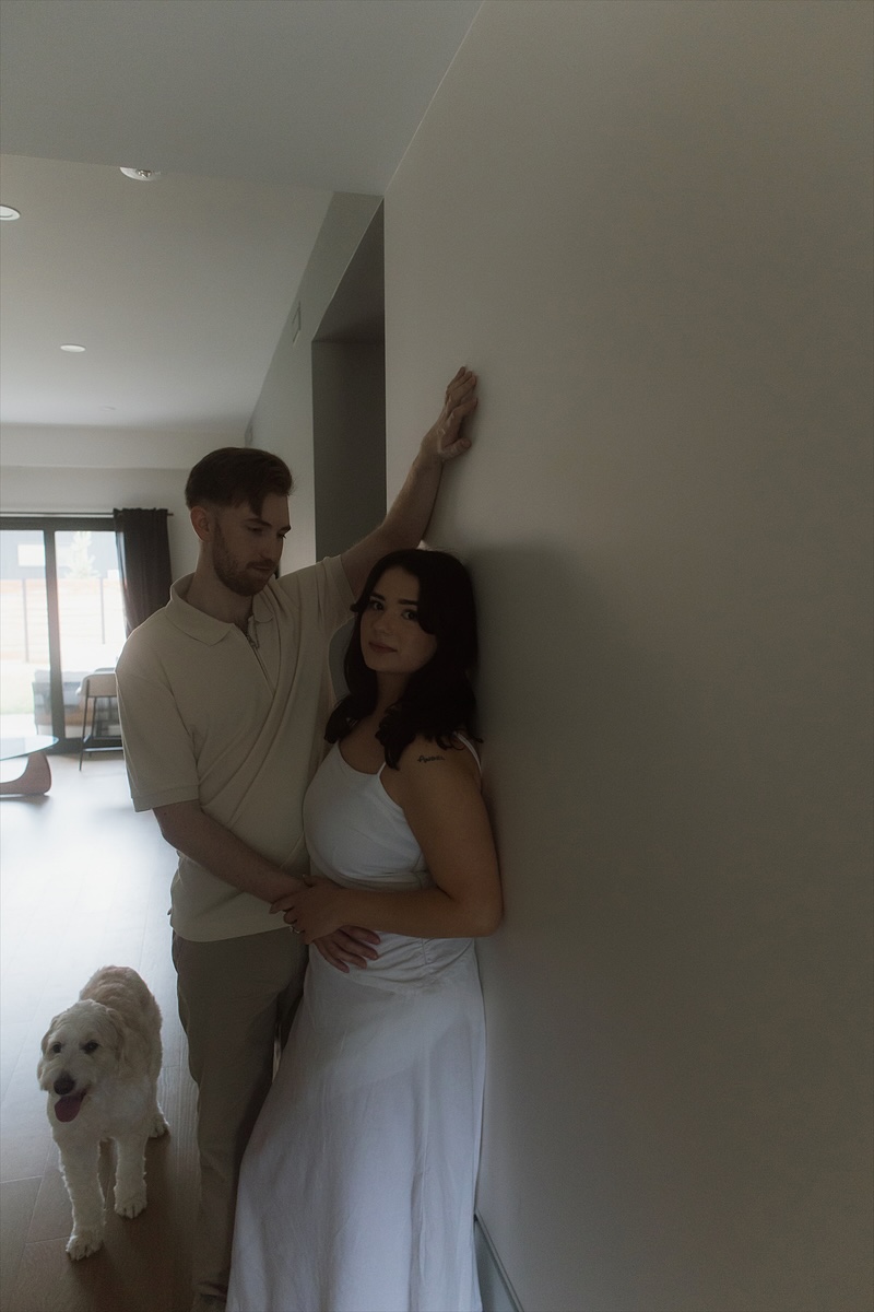 Kaylee and David against the hallway wall, Monty coming to find them