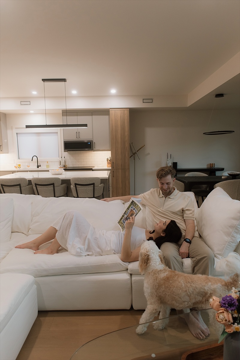 Kaylee reading on the couch, David beside her, Monty in front