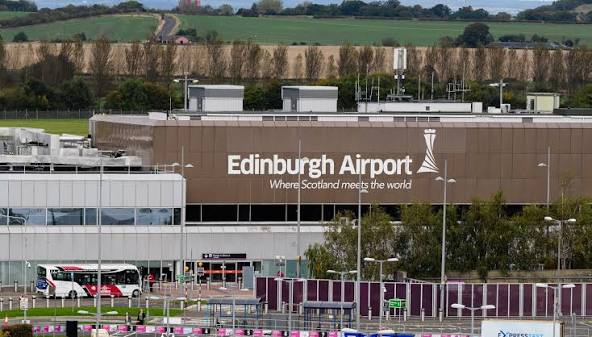 The Edinburgh Airport sign on the terminal building